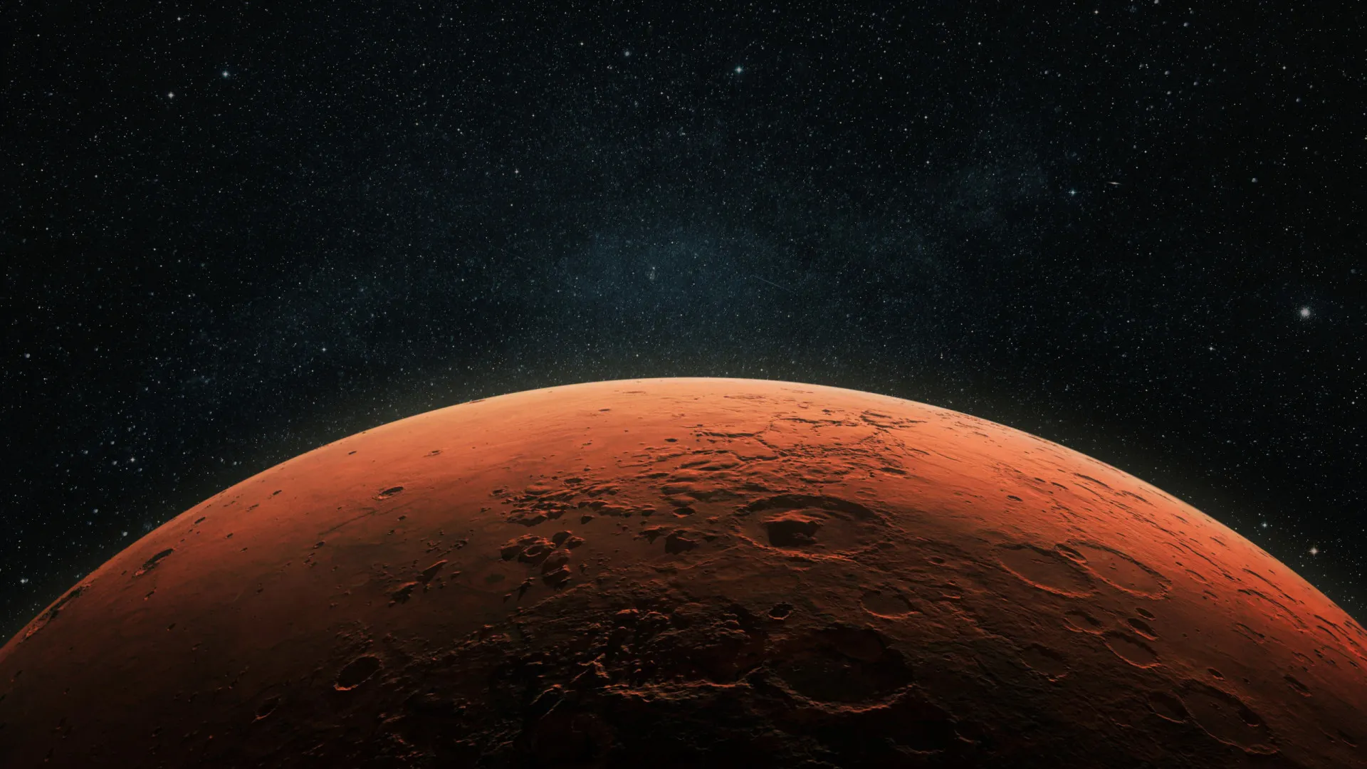 Imagem de Marte mostrando sua distinta cor avermelhada contra o fundo escuro do espaço.
