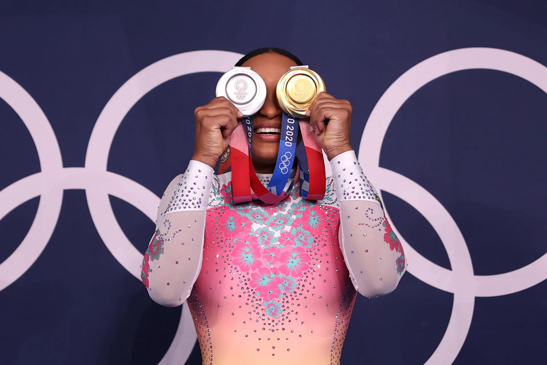Rebeca Andrade posando com suas medalhas de ouro e prata nos Jogos de Tóquio.
