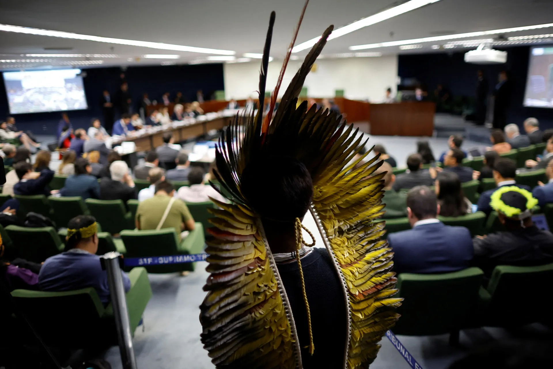 Guerreiro Munduruku com o rosto pintado, olhando com preocupação e determinação.