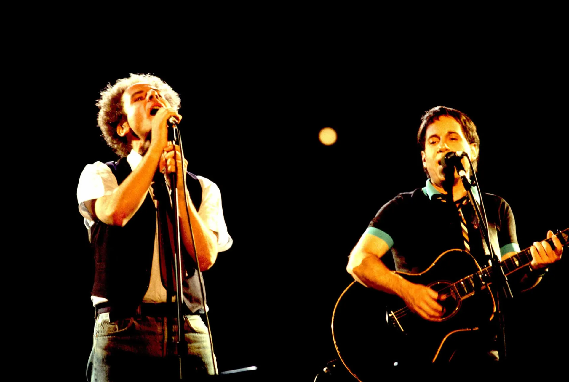 A dupla Simon & Garfunkel em uma foto de época, olhando para a câmera com expressões sérias.