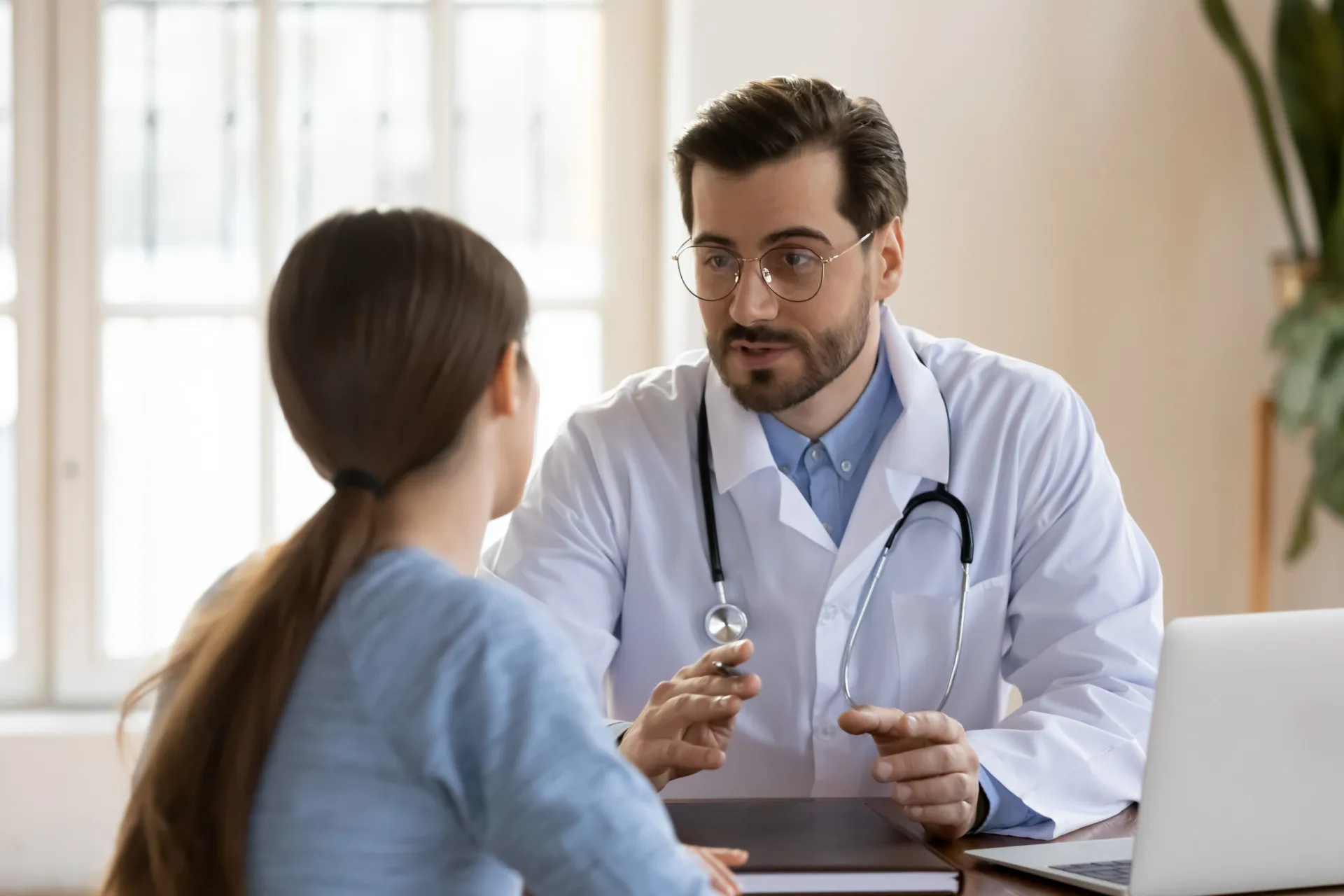 Paciente fazendo perguntas a um médico durante uma consulta.