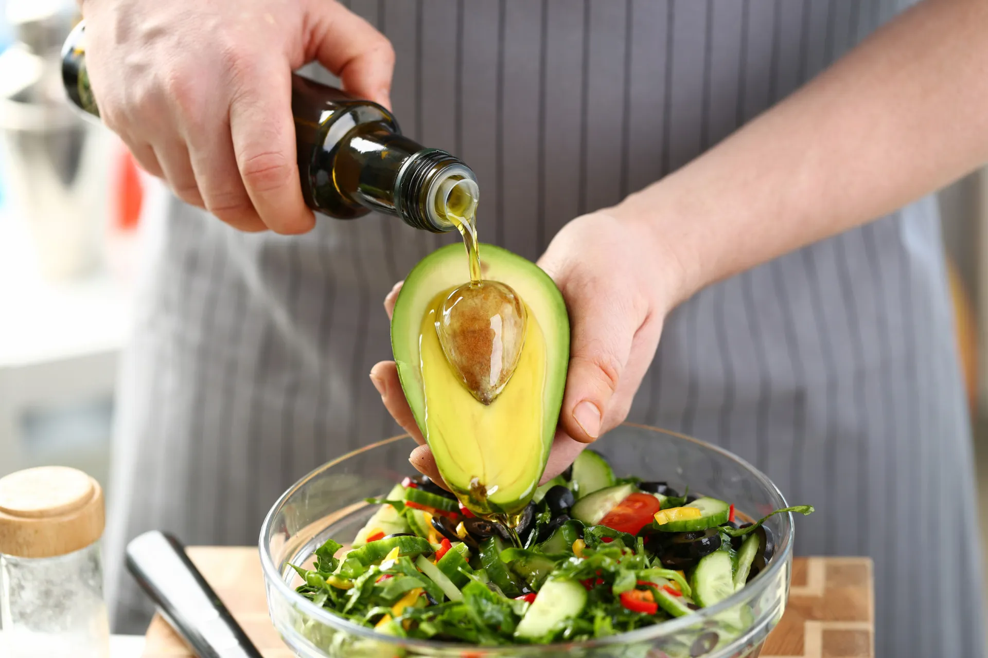Uma salada colorida coberta com fatias de abacate, nozes e sementes de chia.