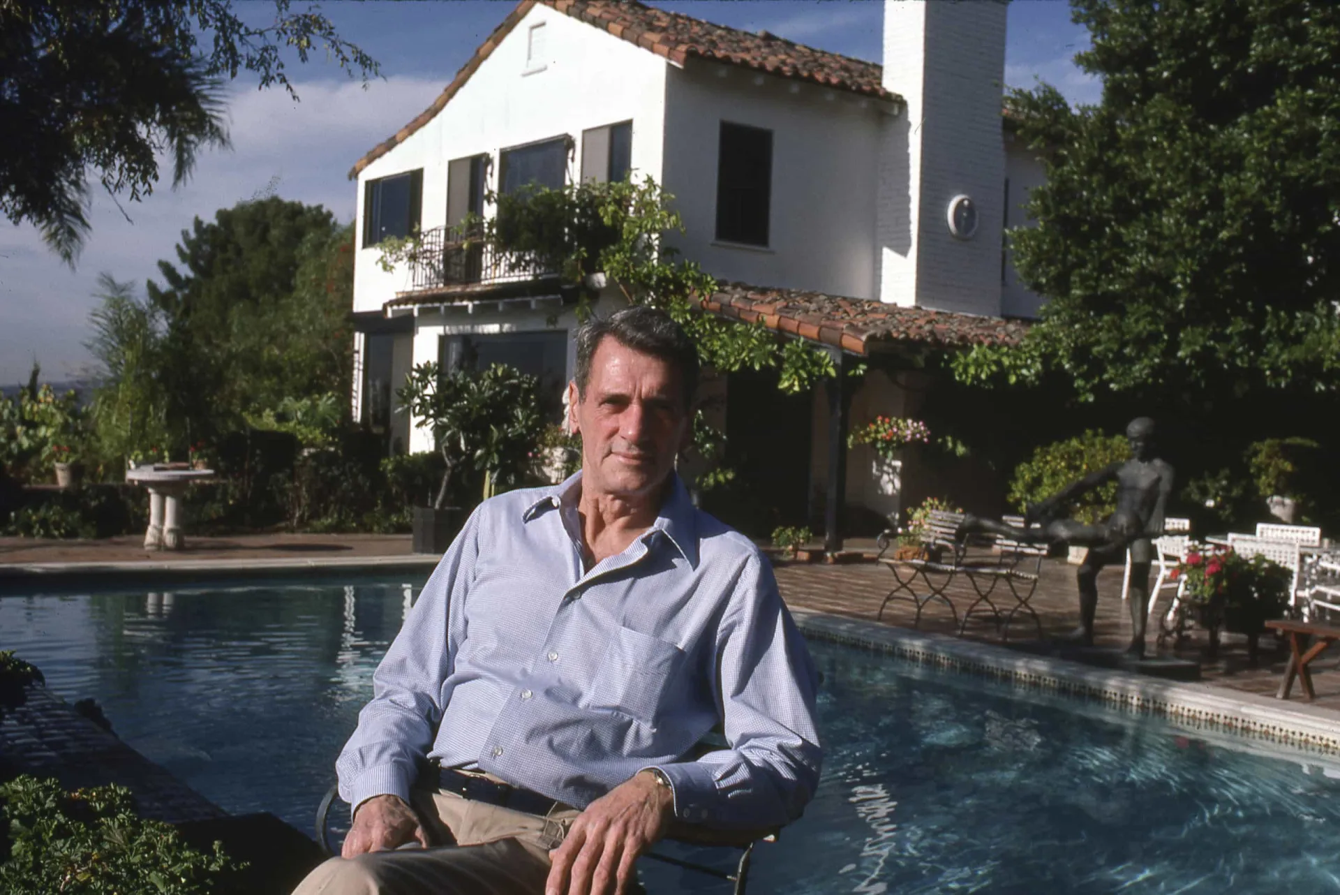 Rock Hudson em uma cena de filme, personificando o charme clássico de Hollywood.