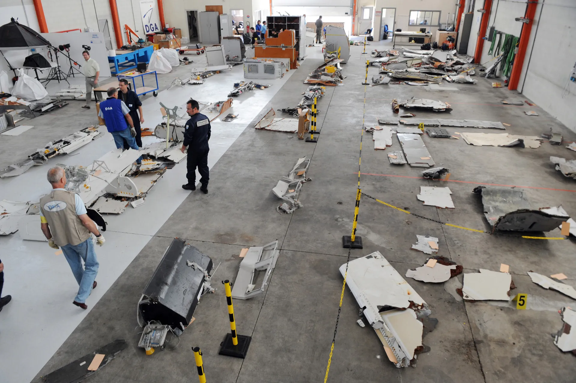 Membros da força aérea organizando os destroços recuperados do voo 447 em um hangar.