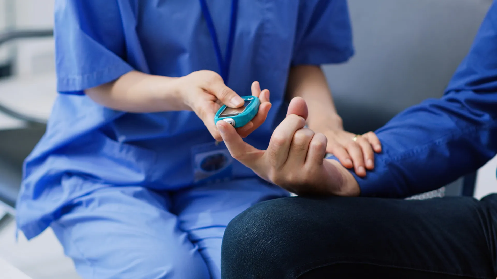 Medidor de glicose mostrando um nível de açúcar no sangue, com uma lanceta ao lado.