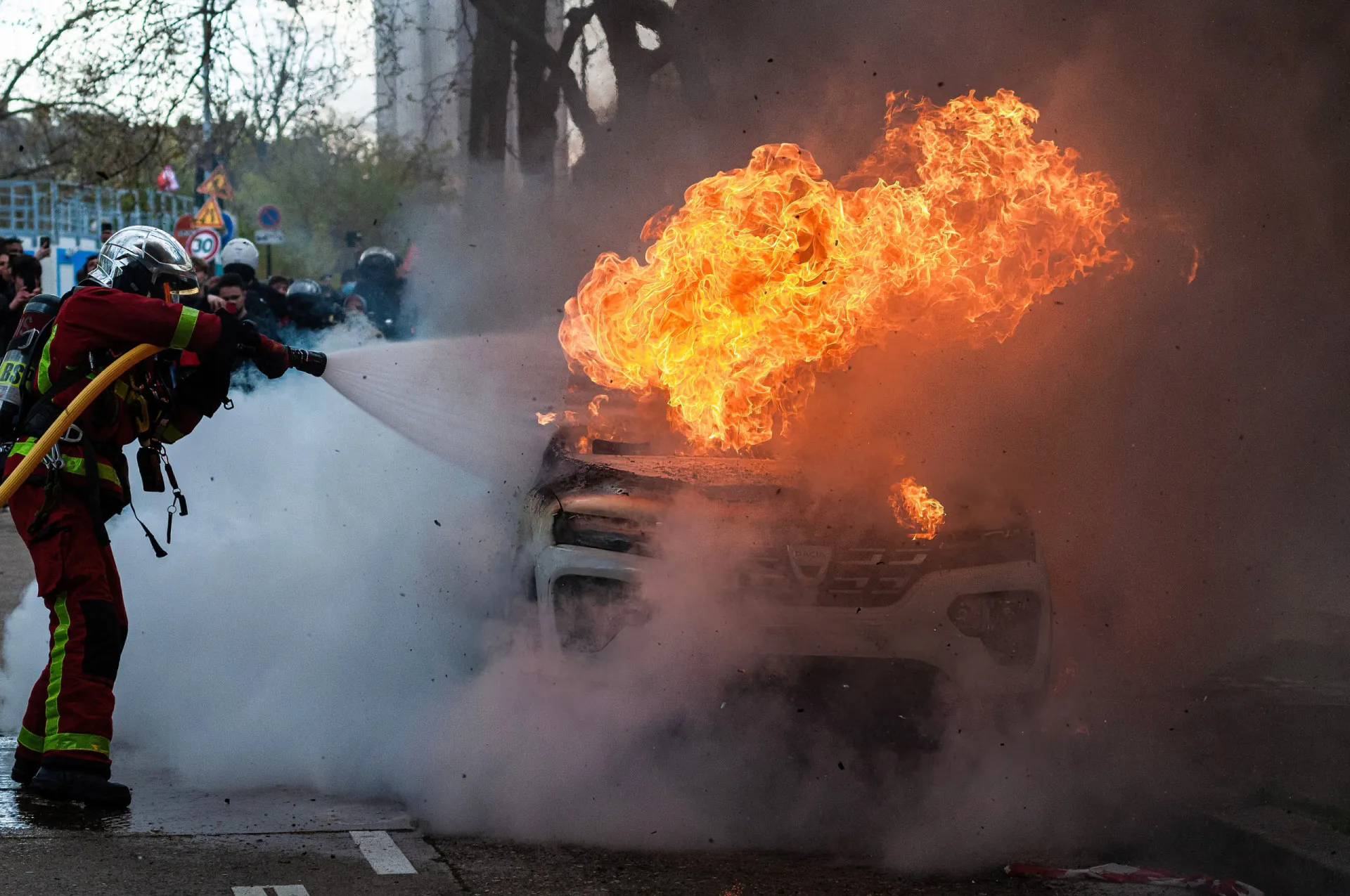 Bombeiros utilizando uma grande quantidade de água para resfriar a bateria de um carro elétrico.