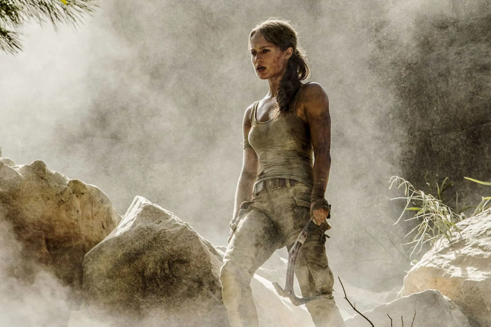 Alicia Vikander como Lara Croft, com um corpo atlético e musculoso, pronta para a aventura.