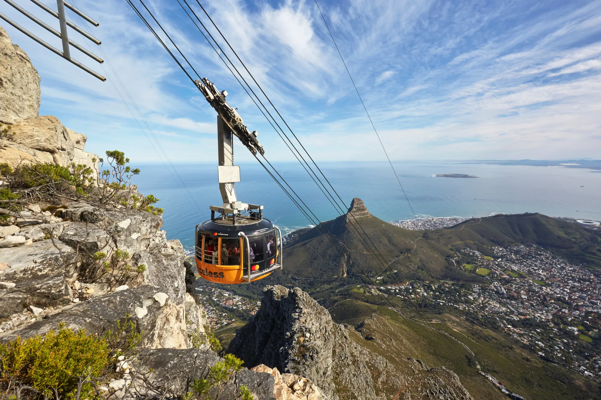O famoso teleférico da Table Mountain subindo em direção ao cume, com a cidade ao fundo.
