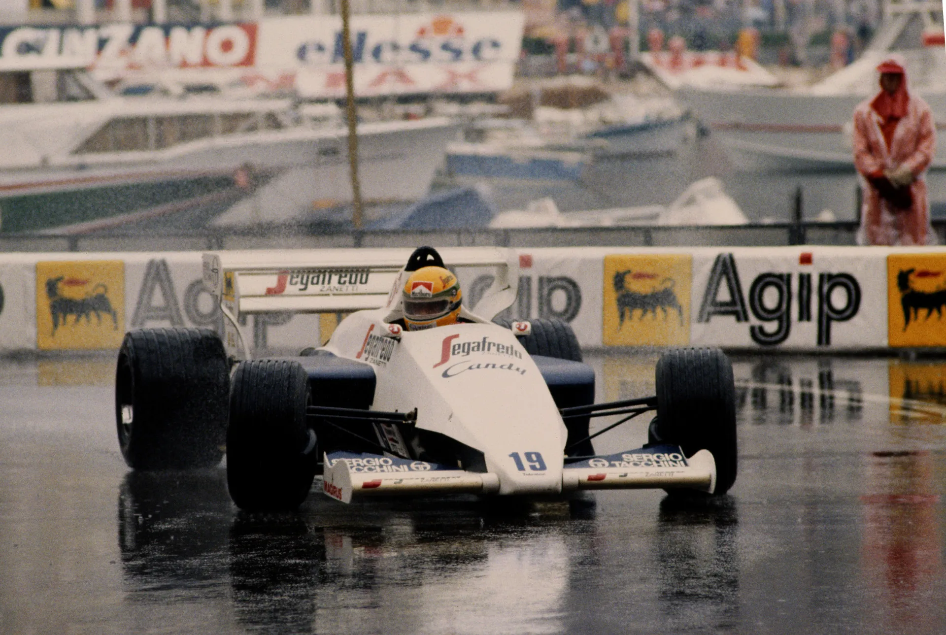 Ayrton Senna pilotando sob forte chuva, demonstrando sua habilidade lendária em condições adversas.