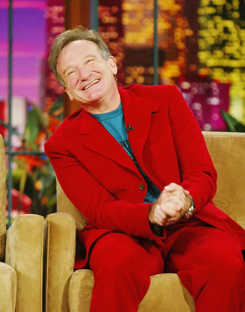Robin Williams sorrindo calorosamente, um de seus traços mais marcantes.