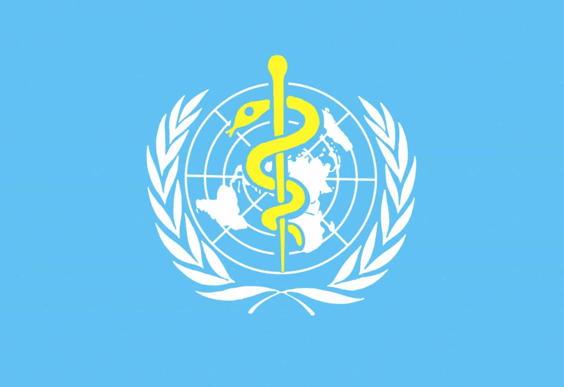 Fachada do prédio da Organização Mundial da Saúde (OMS), com suas bandeiras hasteadas.