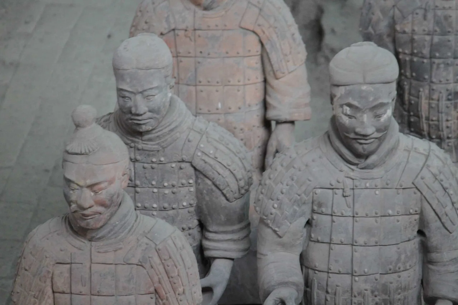 Rosto detalhado de um guerreiro de terracota, mostrando bigode e penteado.