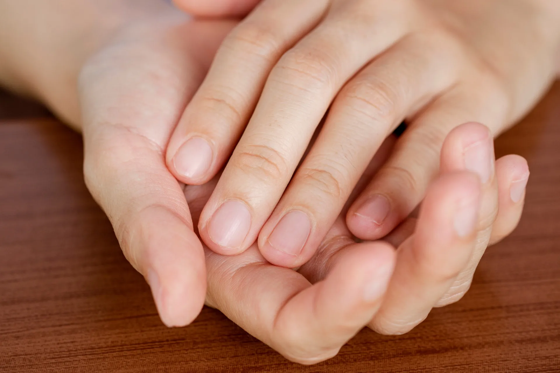 Uma mão com as unhas bem aparadas e lixadas, mantidas curtas.