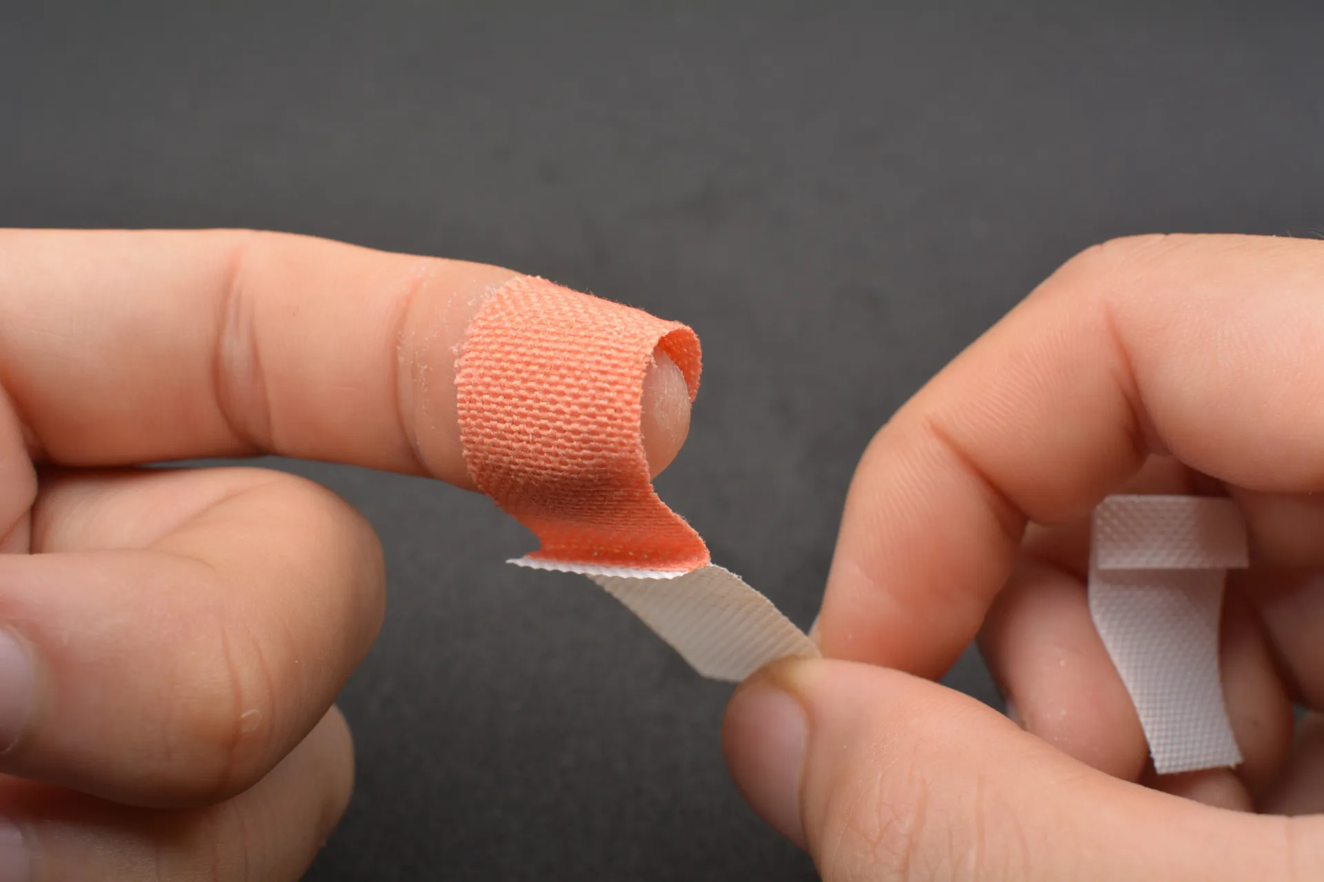 Mãos usando luvas, criando uma barreira física para impedir o ato de roer unhas.