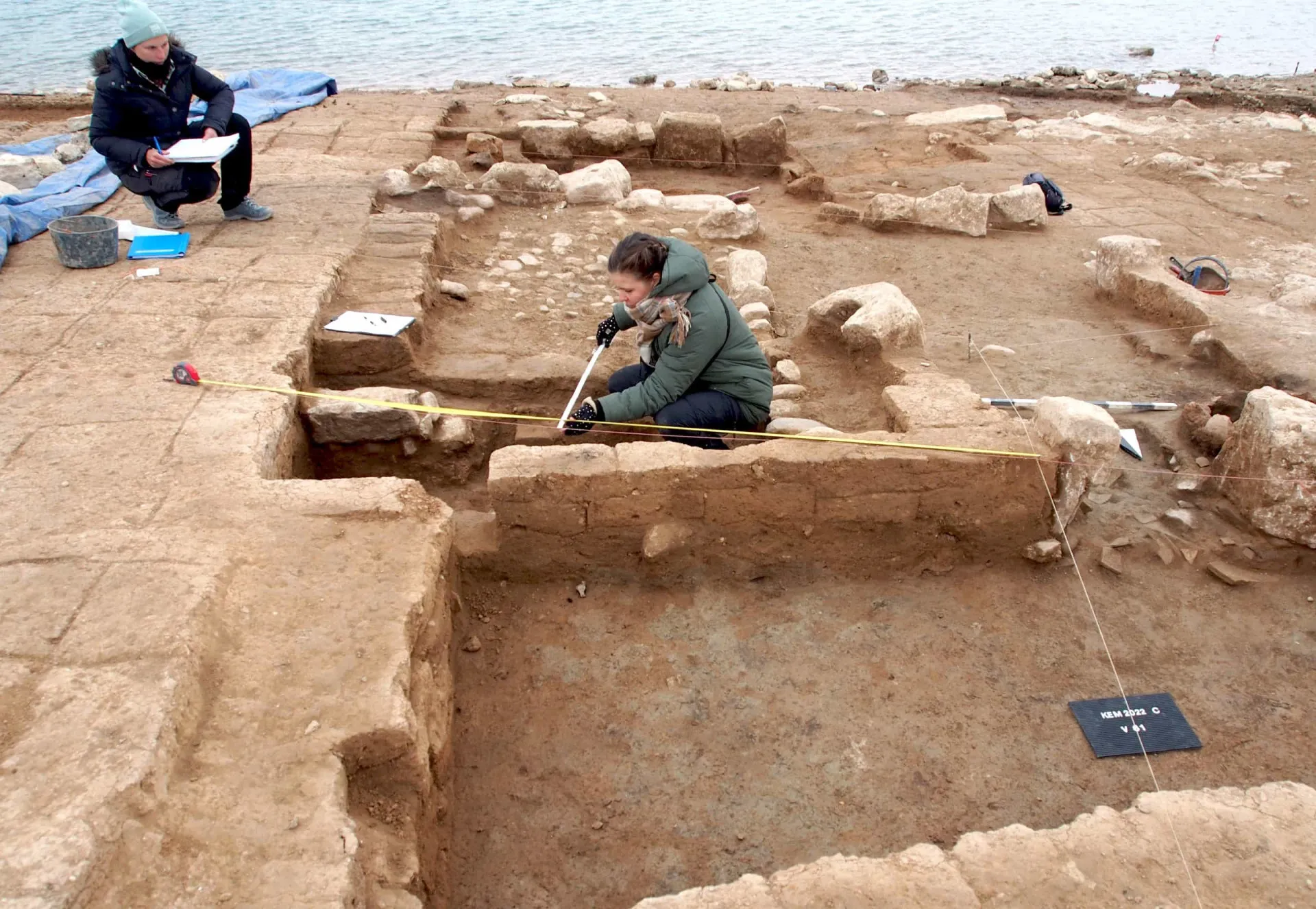Arqueólogos trabalhando cuidadosamente nas ruínas da cidade de Zakhiku.