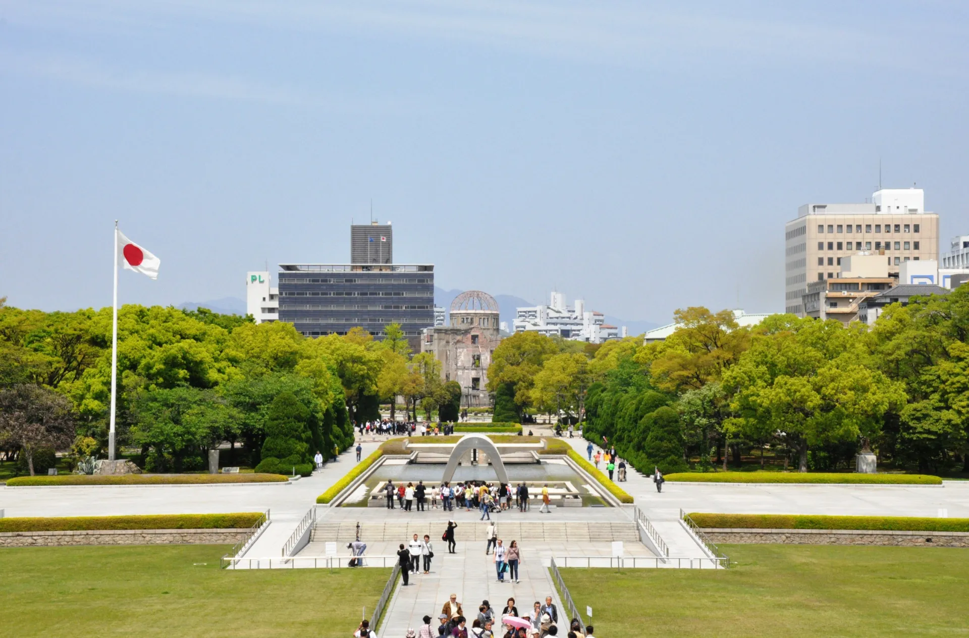 Pessoas em silêncio durante uma cerimônia no Parque Memorial da Paz de Hiroshima.
