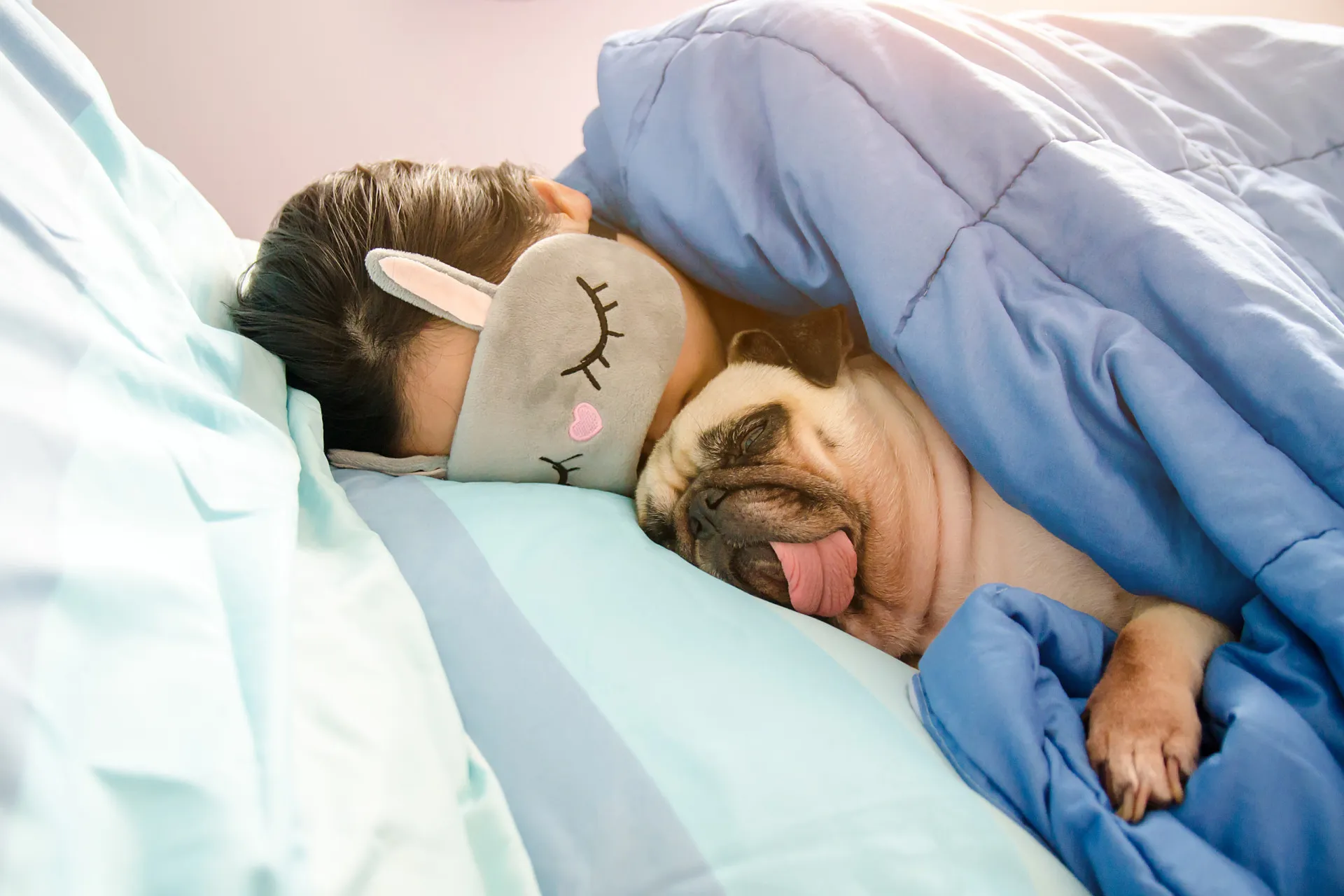 Mulher bocejando e se espreguiçando na cama, parecendo bem descansada.