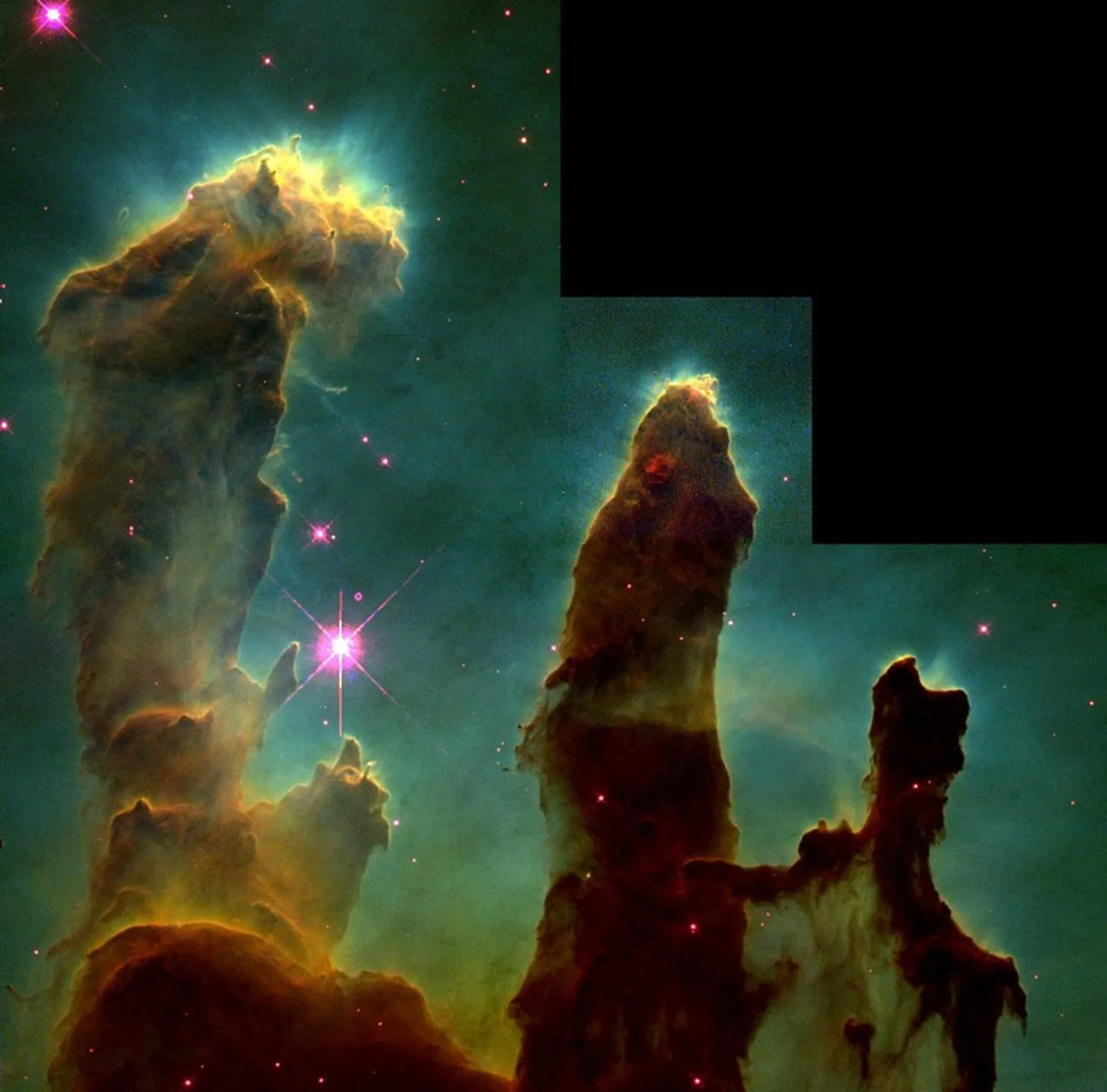 A imagem dos 'Pilares da Criação' na Nebulosa da Águia, mostrando colunas de gás e poeira cósmica.