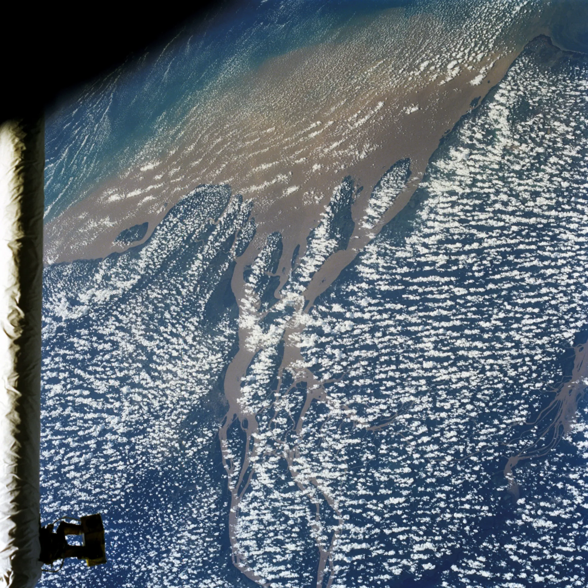 Vista da foz do Rio Amazonas a partir do espaço, mostrando a pluma de sedimentos se encontrando com o Oceano Atlântico.