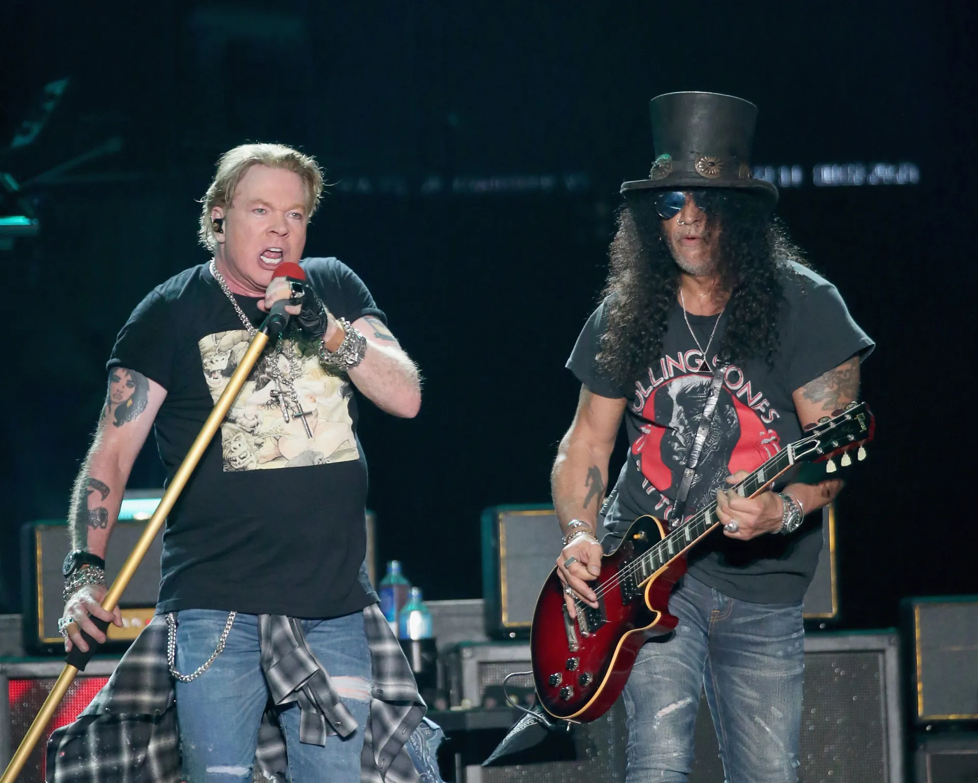 Axl Rose e Slash se apresentando juntos no palco, durante o auge do Guns N' Roses.